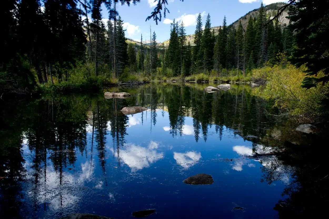 A still alpine lake reflecting the sky near Boulder